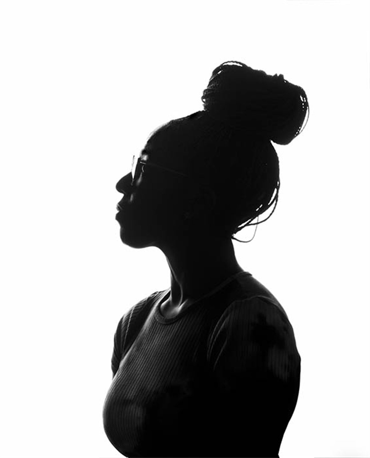Graphic silhouette profile portrait of a woman with a bun
