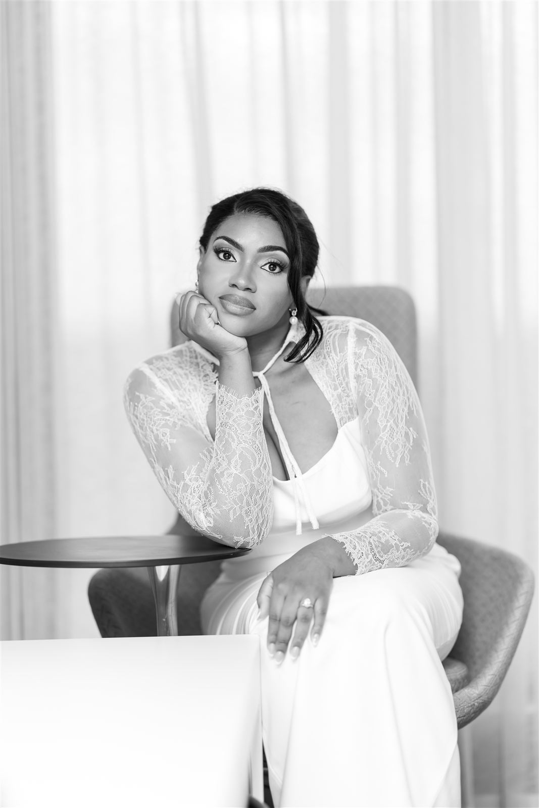 Black and white bridal portrait, bride resting her chin on her hand