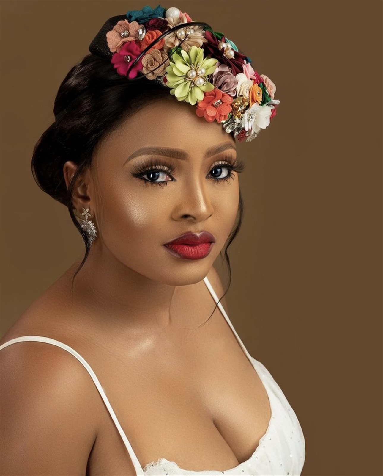 Bride in a floral fascinator headpiece and white gown