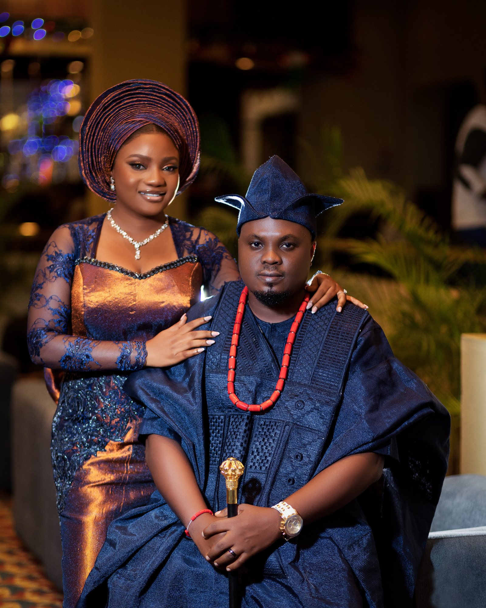 Bride and groom in traditional aso-oke attire, posed together